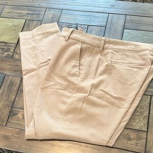 Womens tan slacks with white dot detail.